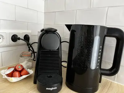 a black appliance sitting on top of a kitchen counter at Have a nice stay! - Little Loft, Summerhouse near the beach in Noordwijk aan Zee