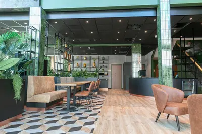 a dining room with a table and chairs at Distrikt Hotels Amsterdam Zaandam in Zaandam