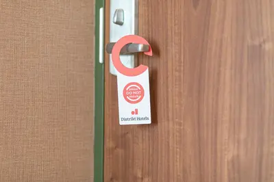 a door with a sign on it attached to it at Distrikt Hotels Amsterdam Zaandam in Zaandam