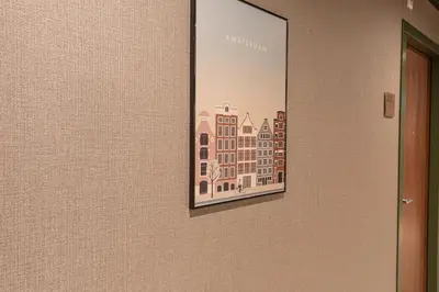 a picture hanging on a wall with a picture on it at Distrikt Hotels Amsterdam Zaandam in Zaandam