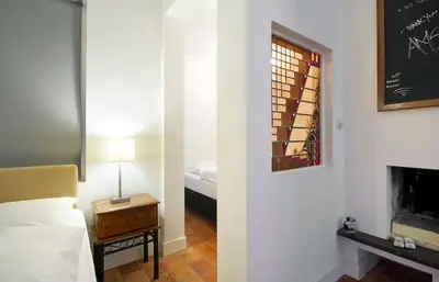 a bedroom with a bed and a table with a lamp at Ground floor Jordaan Apartment in Amsterdam