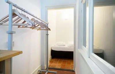 a room with a staircase and a room with a bed at Ground floor Jordaan Apartment in Amsterdam