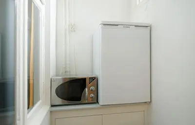 a microwave sitting on a counter next to a window at Ground floor Jordaan Apartment in Amsterdam