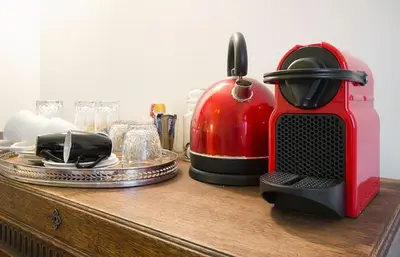a red toaster sitting on a wooden counter at Ground floor Jordaan Apartment in Amsterdam