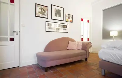 a living room with a chair and a bed at Ground floor Jordaan Apartment in Amsterdam