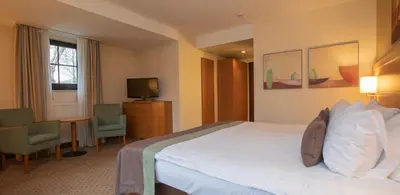 a hotel room with a bed and a television at Fletcher Hotel-Restaurant De Klepperman in Hoevelaken
