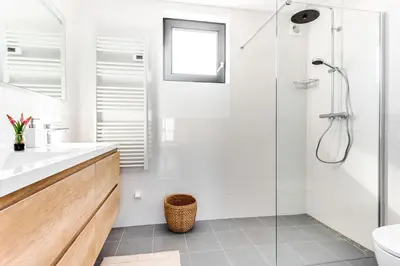 a white bathroom with a shower and a sink at Vernieuwd Zeezicht Villa Strand Luxe in Bergen aan Zee