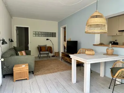 a living room with a table and a couch at Salt Apartment in Zandvoort