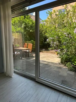 a sliding glass door looking out onto a patio at Salt Apartment in Zandvoort