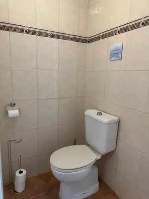 a bathroom with a white toilet in a room at Salt Apartment in Zandvoort