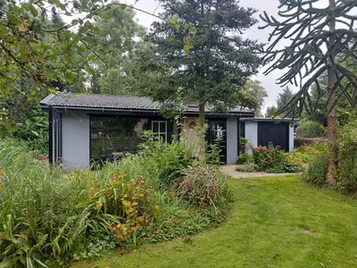 a small house in a garden with a yard at Natuurhuisje Eartswoud in Aartswoud