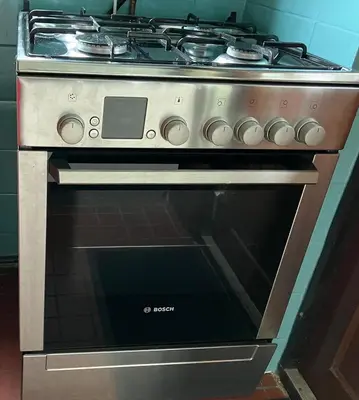 a stainless steel oven with a stove top at Natuurhuisje Eartswoud in Aartswoud