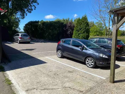 a couple of cars parked in a parking lot at La Luna - Denise in Heerhugowaard