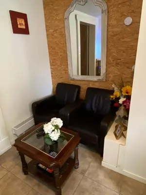 a living room with a black couch and a table at La Luna - Denise in Heerhugowaard