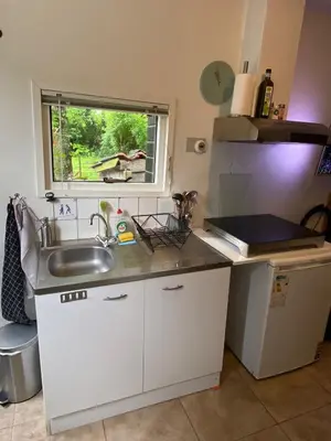 a small kitchen with a sink and a window at La Luna - Denise in Heerhugowaard