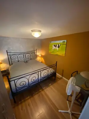 a bedroom with a bed and a painting on the wall at La Luna - Denise in Heerhugowaard