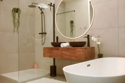 a bathroom with a tub and a sink and a mirror at Luxury Harbour Suite With Private Parking in Loosdrecht