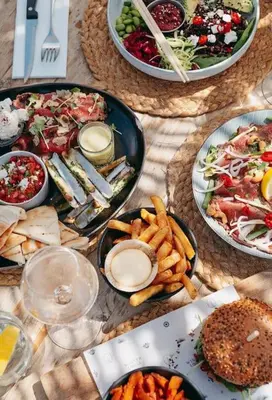 a table topped with plates of food and french fries at Luxury Harbour Suite With Private Parking in Loosdrecht