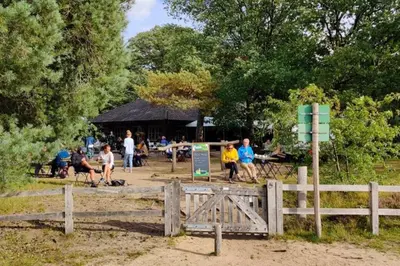 a group of people in a park behind a fence at Luxury Harbour Suite With Private Parking in Loosdrecht