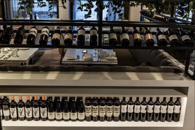 a bunch of bottles of wine on a shelf at Luxury Harbour Suite With Private Parking in Loosdrecht