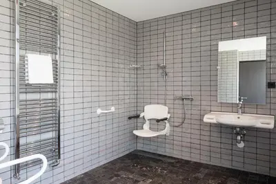 a bathroom with a sink and a toilet and a mirror at Apollo Hotel Amsterdam, a Tribute Portfolio Hotel in Amsterdam