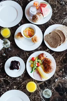 a group of plates of food on a table at Apollo Hotel Amsterdam, a Tribute Portfolio Hotel in Amsterdam