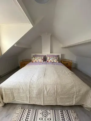 a bedroom with a large bed in an attic at Beach Bliss in Noordwijk