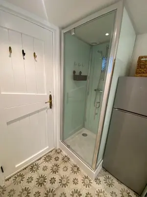 a shower with a glass door in a bathroom at Beach Bliss in Noordwijk