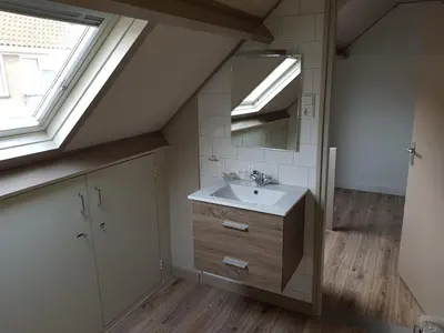 a bathroom with a sink and a mirror at Brugman in Egmond aan Zee