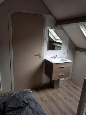 a bathroom with a sink and a mirror at Brugman in Egmond aan Zee
