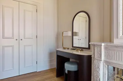 a bathroom with a vanity and a mirror at Waldorf Astoria Amsterdam in Amsterdam