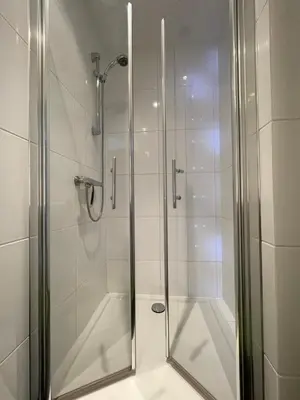 a shower with a glass door in a bathroom at Holiday in Spakenburg Ootje in Spakenburg