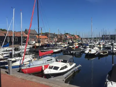 a bunch of boats are docked in a harbor at Holiday in Spakenburg Ootje in Spakenburg