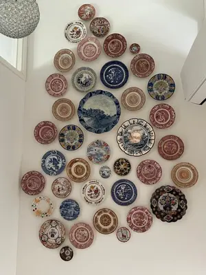 a wall filled with lots of plates on a wall at Holiday in Spakenburg Ootje in Spakenburg