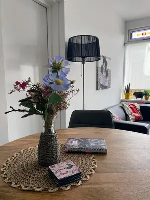a vase with flowers on a table in a living room at Holiday in Spakenburg Ootje in Spakenburg