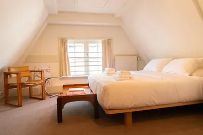a bedroom with a bed with towels on it at hotel calisto in Amsterdam