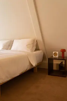 a bedroom with a bed and a side table at hotel calisto in Amsterdam