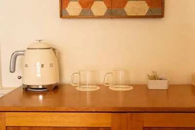 a kitchen counter with a blender and two glasses on it at hotel calisto in Amsterdam
