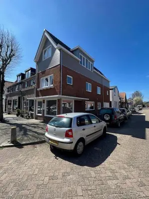 a car parked in a parking lot in front of a building at Duinroos aan Zee in Egmond aan Zee