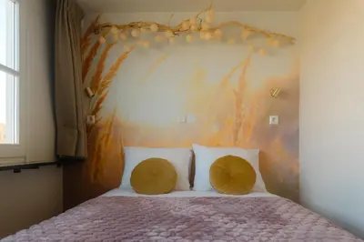 a bedroom with a bed with two pillows at Huisje Hartenlust in Bodegraven