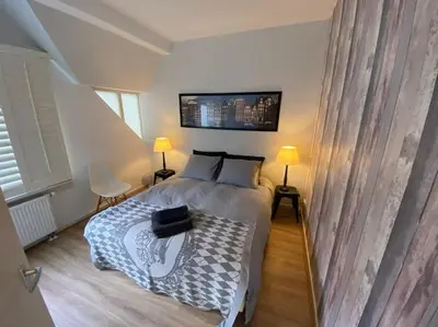 a bedroom with a bed and two lamps and a bed sidx sidx sidx at Beach nearby, close to Amsterdam, The Hague -6p in Wassenaar