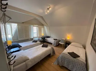 a bedroom with two beds and a living room at Beach nearby, close to Amsterdam, The Hague -6p in Wassenaar