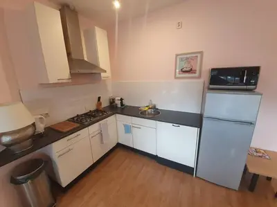 a kitchen with white cabinets and a white refrigerator at Beach nearby, close to Amsterdam, The Hague -6p in Wassenaar