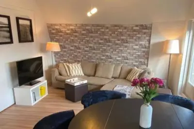 a living room with a couch and a table at Beach nearby, close to Amsterdam, The Hague -6p in Wassenaar