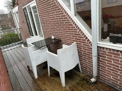 two white chairs and a table on a porch at Beach nearby, close to Amsterdam, The Hague -6p in Wassenaar