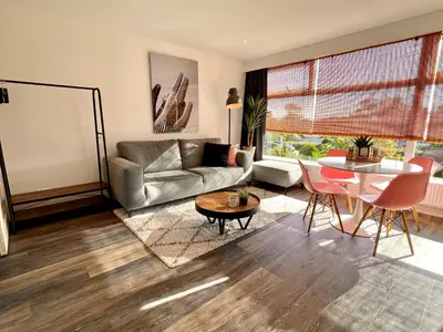 a living room with a couch and a table at @54 in Zandvoort