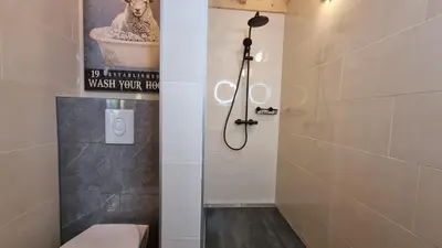 a bathroom with a shower and a toilet in it at City Farmers Lodge, a Guesthouse with a skyline view in Rural Amsterdam in Amsterdam