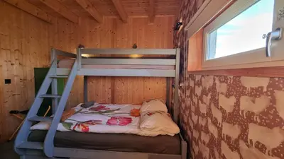 a bunk bed in a room with a ladder at City Farmers Lodge, a Guesthouse with a skyline view in Rural Amsterdam in Amsterdam