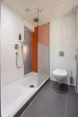 a white bathroom with a shower and a toilet at Fletcher Hotel-Restaurant Nieuwegein-Utrecht in Nieuwegein