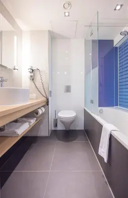 a bathroom with a tub and a toilet and a sink at Fletcher Hotel-Restaurant Nieuwegein-Utrecht in Nieuwegein